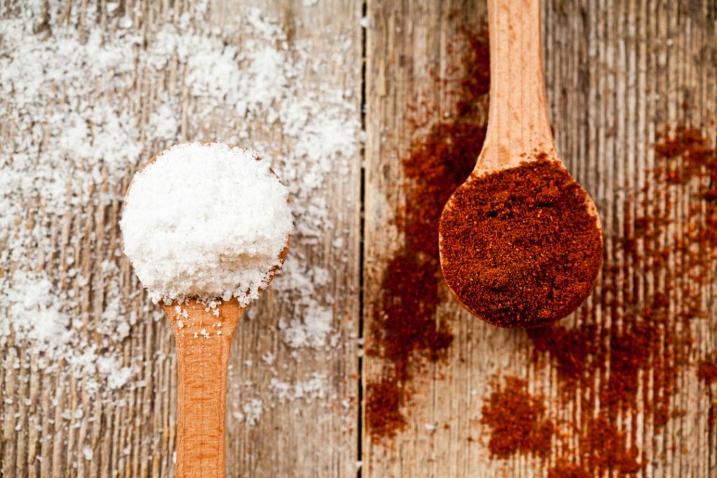 A wooden spoon with powdered sugar and a wooden spoon