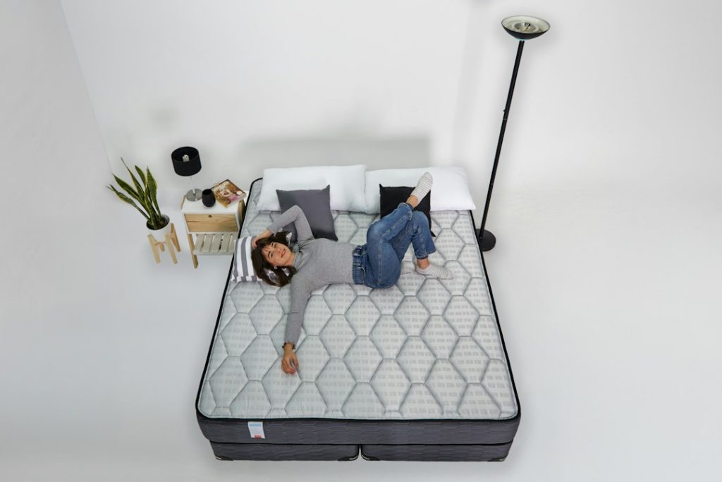 Woman relaxing on a mattress with headphones on